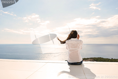 Image of girl listening to the music on white headphones