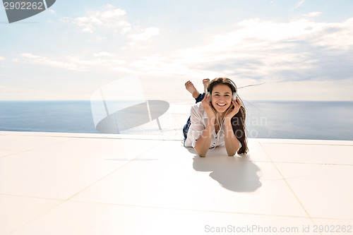 Image of girl listening to the music on white headphones