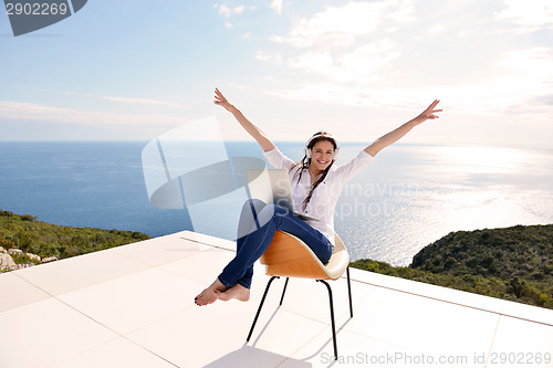 Image of relaxed young woman at home working on laptop