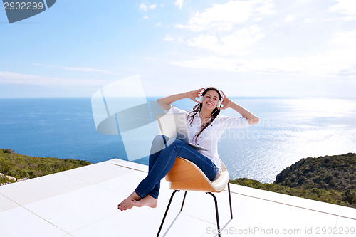 Image of relaxed young woman at home working on laptop