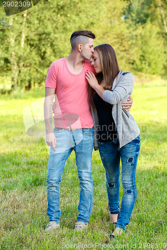 Image of Happy kissing young couple outdoor