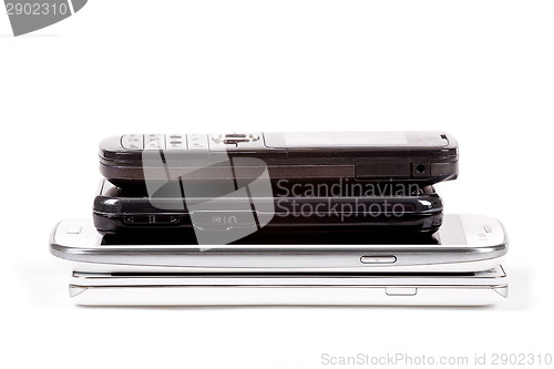 Image of Stack of older model cell phones and smartphones