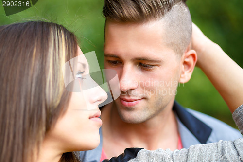 Image of Happy smiling young couple outdoor