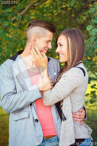 Image of Happy smiling young couple outdoor