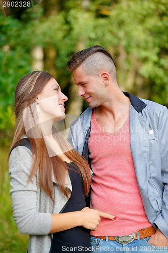 Image of Happy smiling young couple outdoor