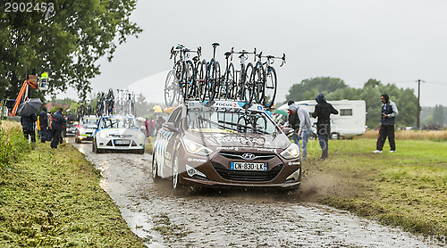 Image of Row of Technical Cars on a Cobbled Road - Tour de France 2014