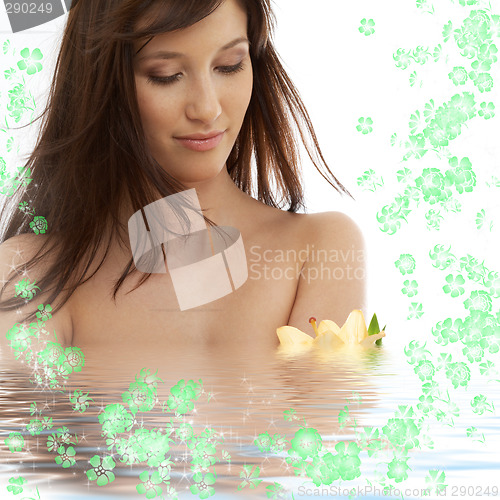 Image of brunette with yellow lily and flowers in water