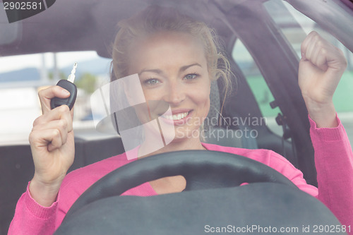 Image of Woman driver showing car keys.