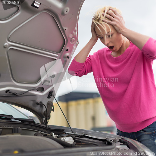 Image of Stressed Young Woman with Car Defect.