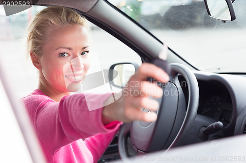 Image of Woman driver showing car keys.