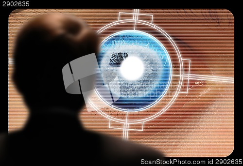 Image of Man viewing a retinal eye scan on a video monitor