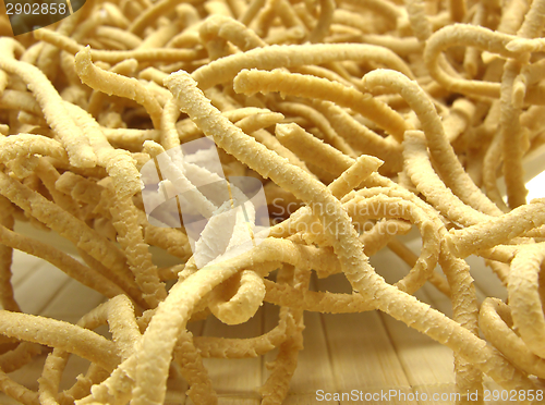 Image of A close up view at uncooked wholemeal spaetzle on a placemat