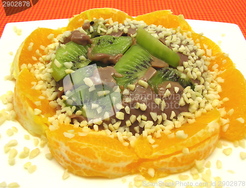 Image of Chocolate pudding with kiwi fruit, orange and little pieces of a