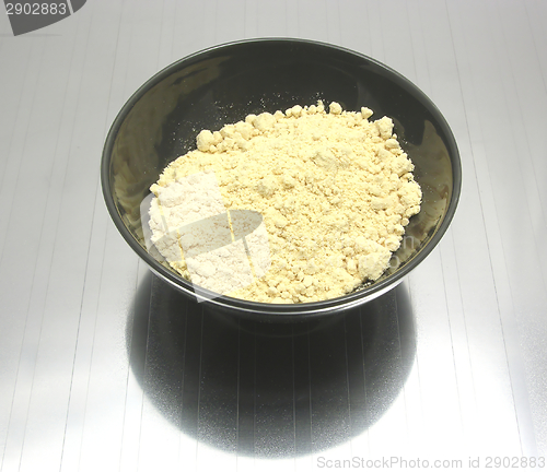 Image of Bowl of chinaware with soy meal on reflecting matting