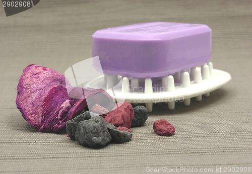 Image of Lilac soap with decoration articles on a  gray background