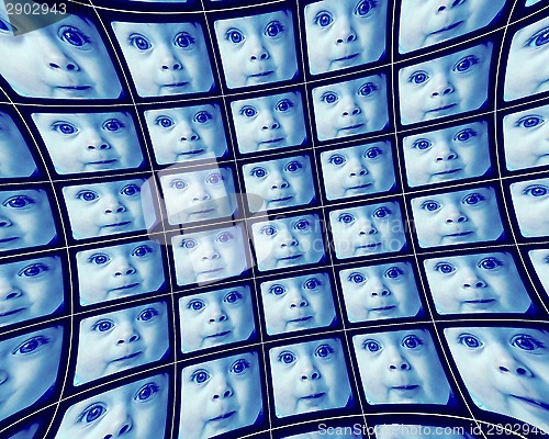 Image of Distorted blue video screens showing the face of a baby