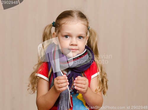 Image of Girl with a sore throat in warm scarf