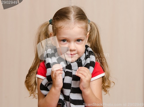 Image of The three-year girl in a diseased warm scarf