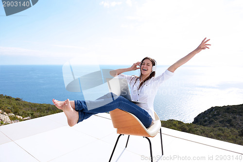 Image of relaxed young woman at home working on laptop