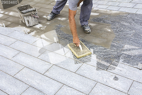 Image of Grouting tiles on the floor