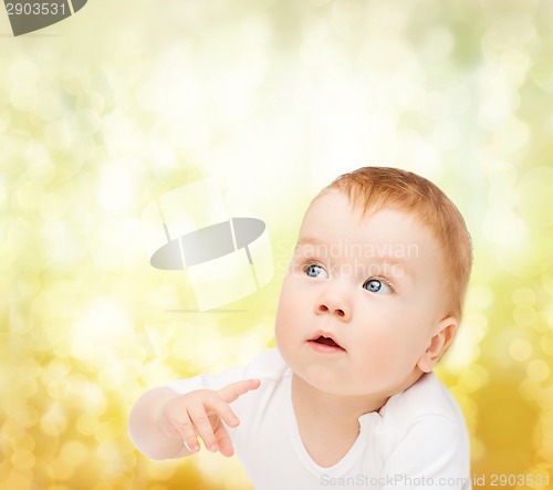 Image of curious baby looking side