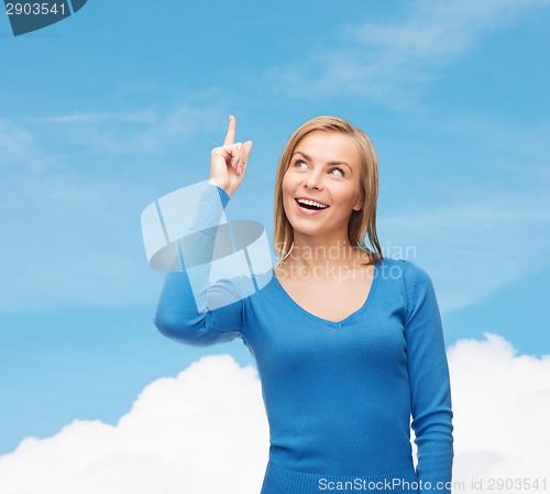 Image of smiling woman pointing her finger up