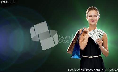 Image of smiling woman in dress with shopping bags