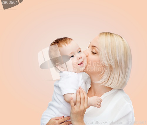 Image of happy mother kissing smiling baby