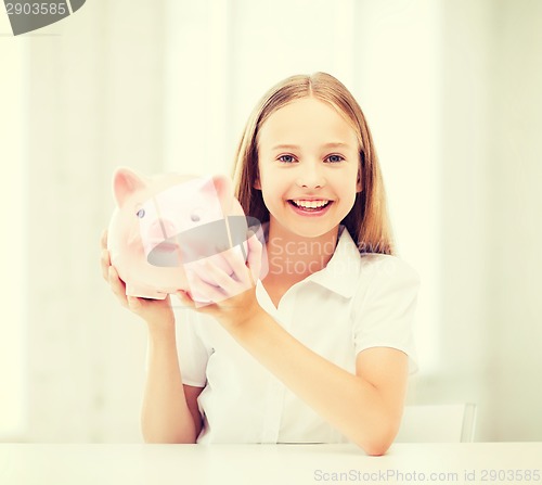 Image of child with piggy bank