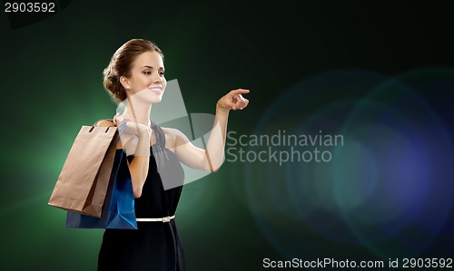 Image of smiling woman in dress with shopping bags