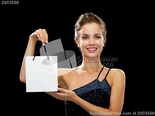 Image of smiling woman with white blank shopping bag