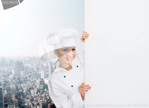 Image of smiling female chef with white blank board