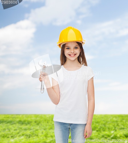 Image of smiling little girl in hardhat with wrench