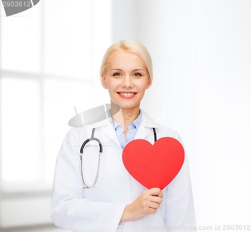 Image of smiling female doctor with heart and stethoscope