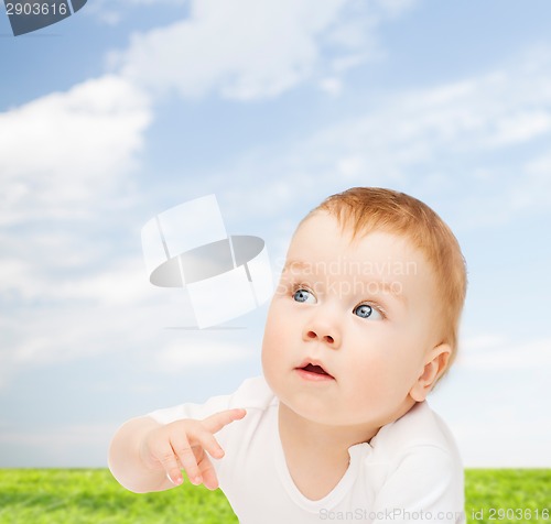 Image of curious baby looking side