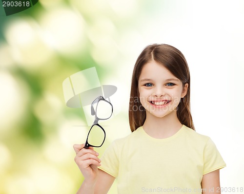 Image of smiling cute little girl holding black eyeglasses