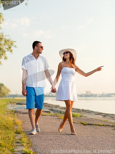 Image of smiling couple walking outdoors