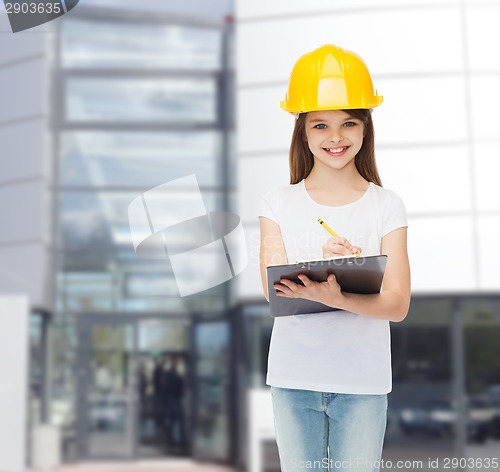 Image of smiling little girl in hardhat with clipboard