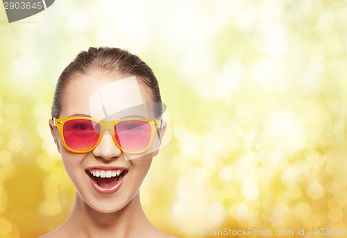 Image of happy teenage girl in pink sunglasses