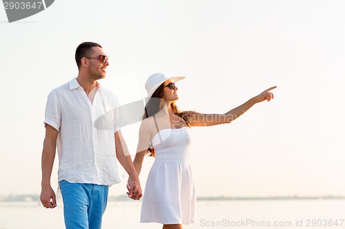 Image of smiling couple walking outdoors