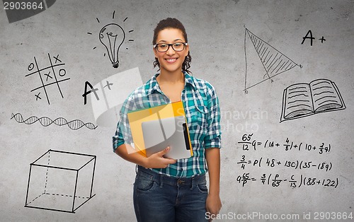 Image of student in eyeglasses with folders and tablet pc