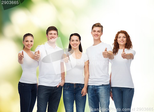 Image of smiling teenagers in t-shirts showing thumbs up