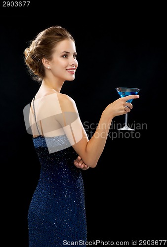 Image of smiling woman holding cocktail