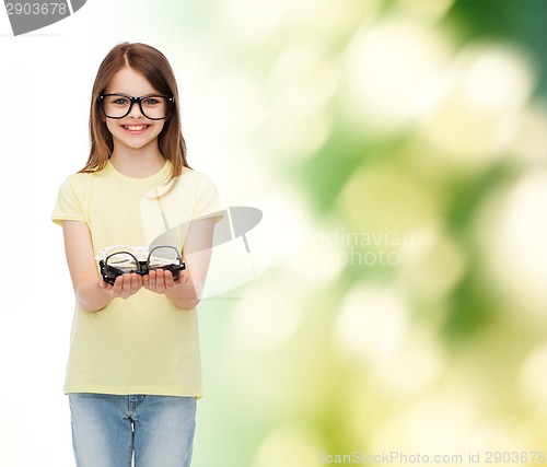 Image of smiling cute little girl in black eyeglasses