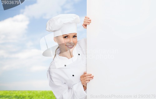 Image of smiling female chef with white blank board