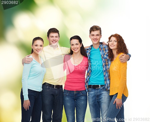 Image of group of smiling teenagers over green background