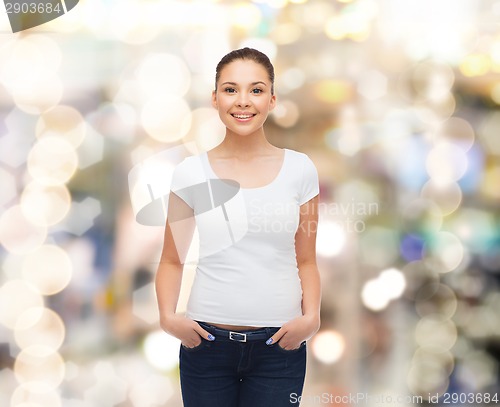 Image of smiling young woman in blank white t-shirt