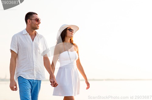 Image of smiling couple walking outdoors