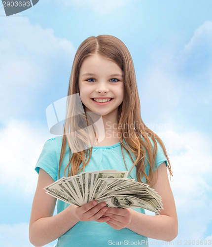 Image of smiling little girl with dollar cash money