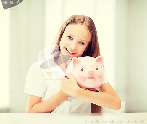 Image of child with piggy bank